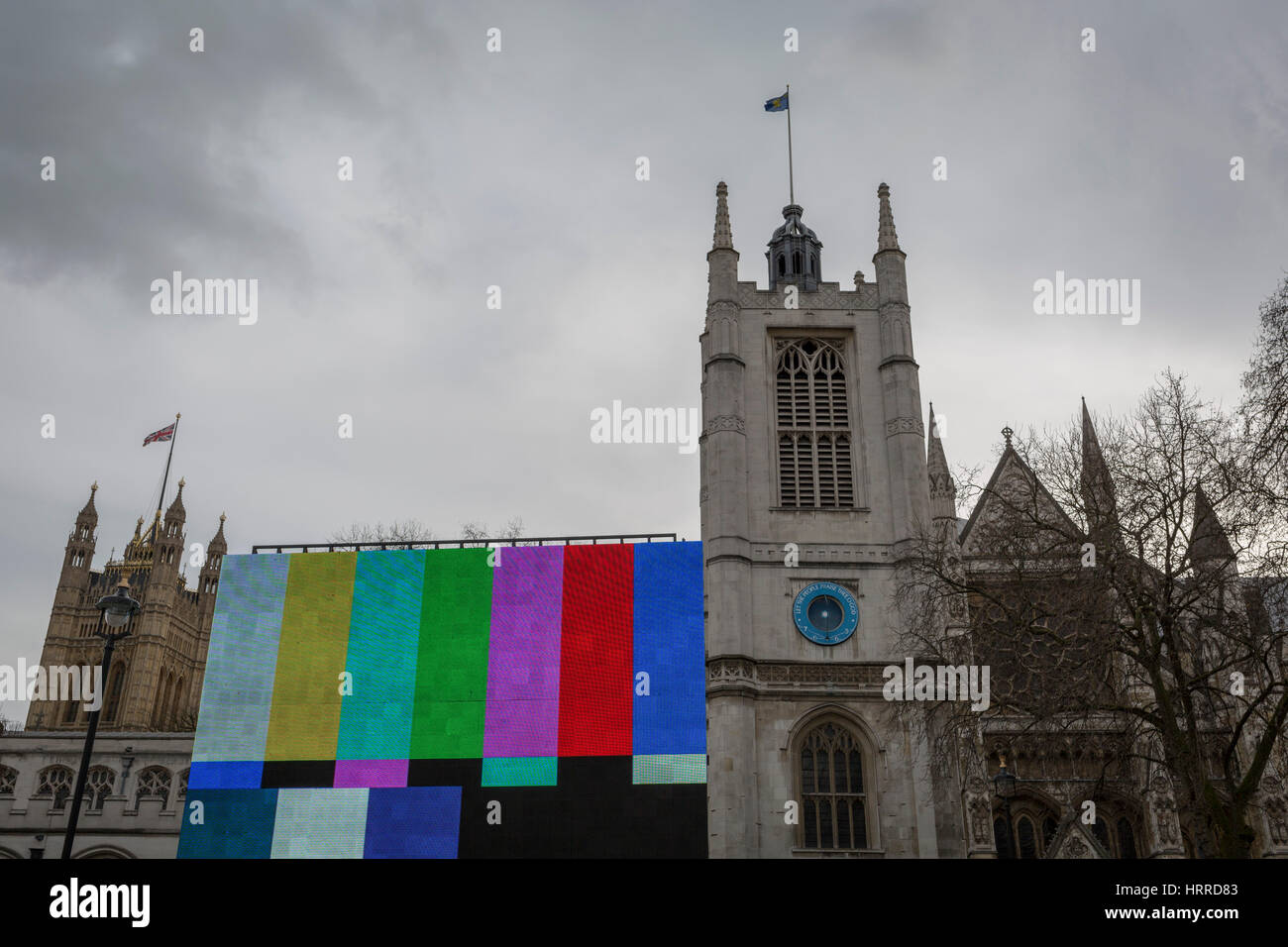 Colour bars on a giant TV screen seen in Parliament Square and outside Westminster Abbey, on 20th February 2017, in London, England. SMPTE color bars is a television test pattern used where the NTSC video standard is utilized, including countries in North America. The Society of Motion Picture and Television Engineers (SMPTE) refers to this test pattern as Engineering Guideline EG 1-1990. Stock Photo