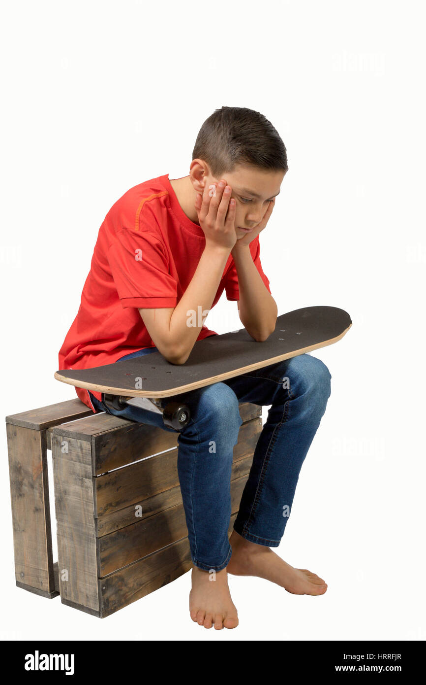 Young teenage caucasian boy with his skateboard Stock Photo