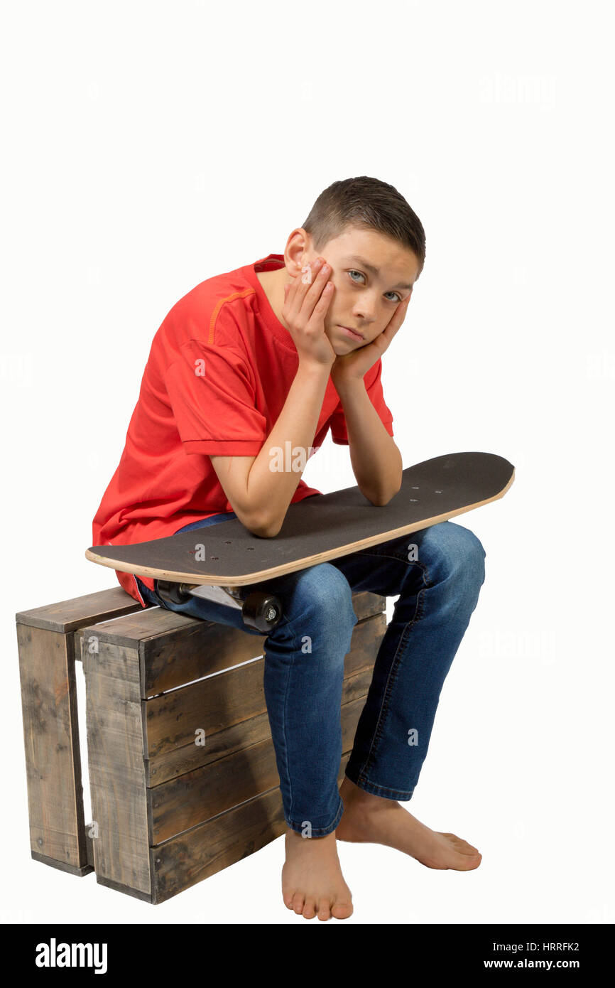 Young teenage caucasian boy with his skateboard Stock Photo