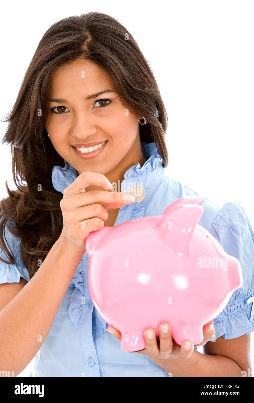 casual woman saving money in a piggy bank isolated on white Stock Photo