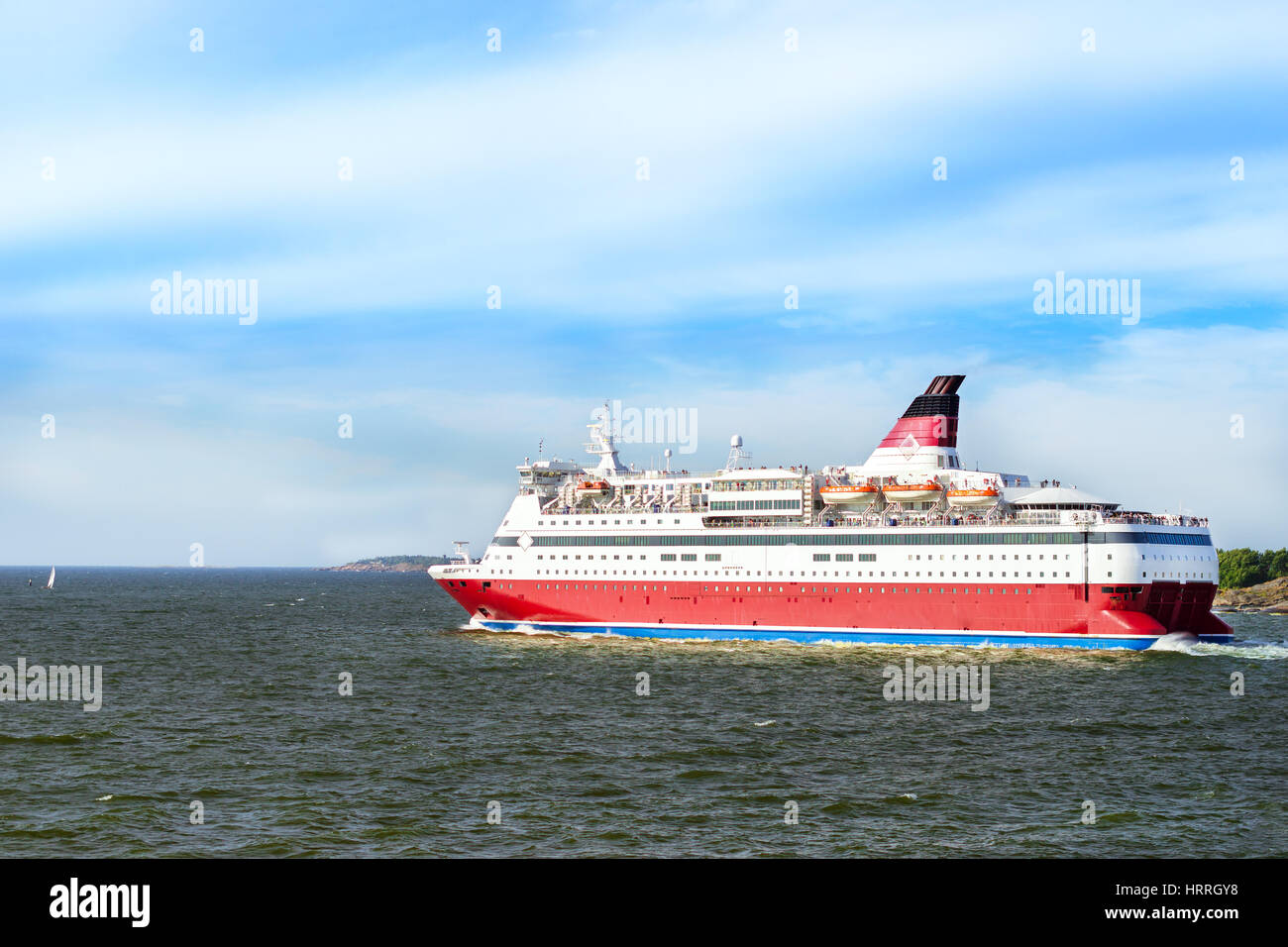 Cargo-passenger cruise ferry goes from port Helsinki across Bay Kruunuvuorenselka near island Suomenlinna. Suomi, Helsingfors, South Gulf Stock Photo