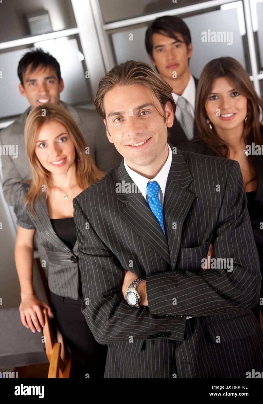 group of business people standing in an office smiling Stock Photo - Alamy