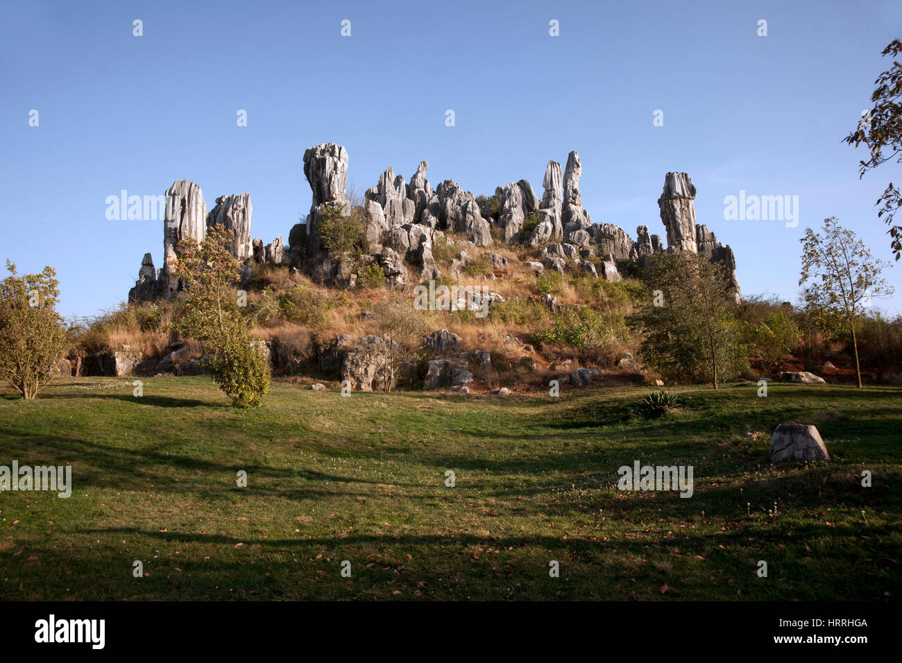 White grey colored tall standing rocks on a hill, China Stock Photo - Alamy