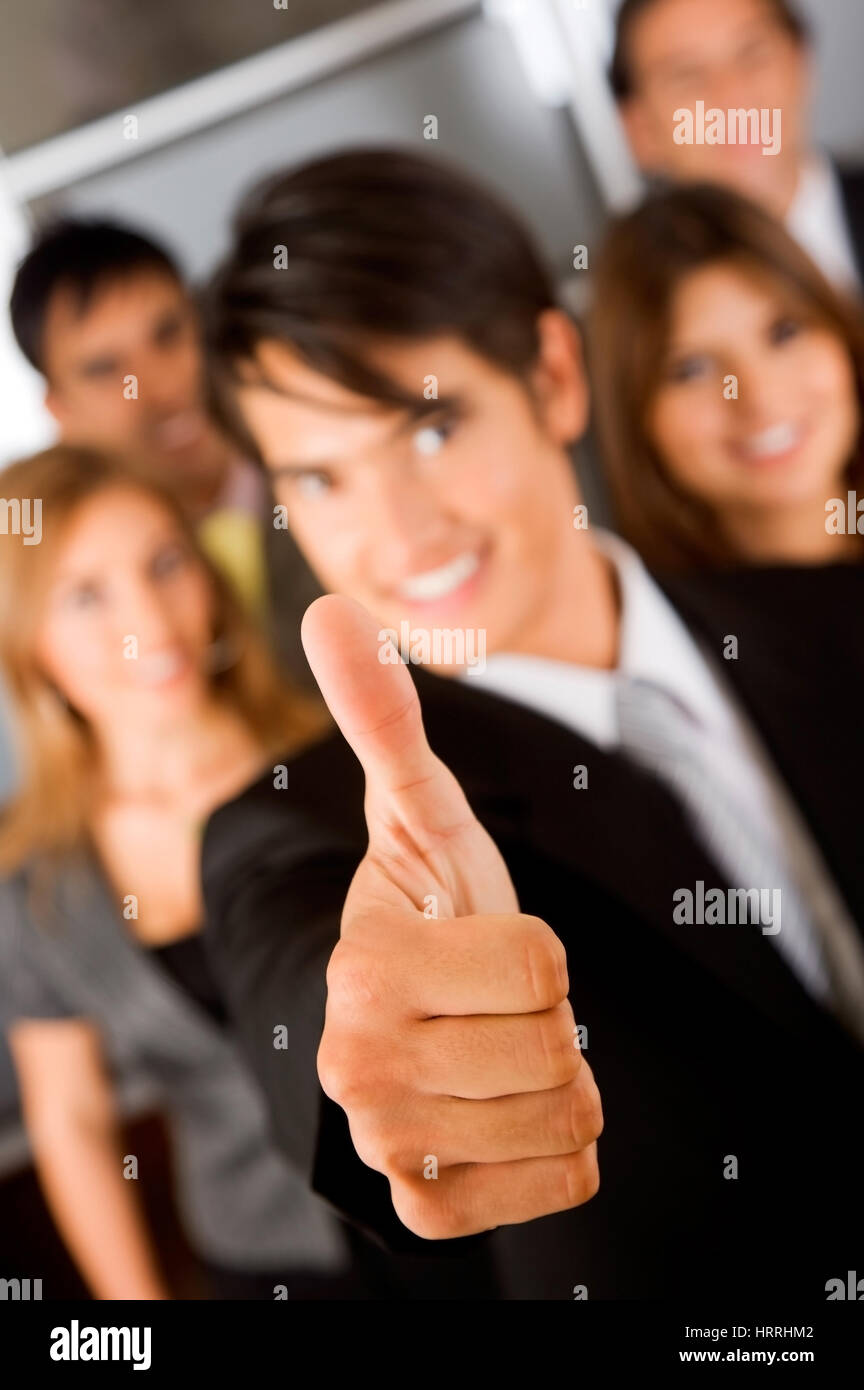 business man with his thumb up - business team behind Stock Photo - Alamy