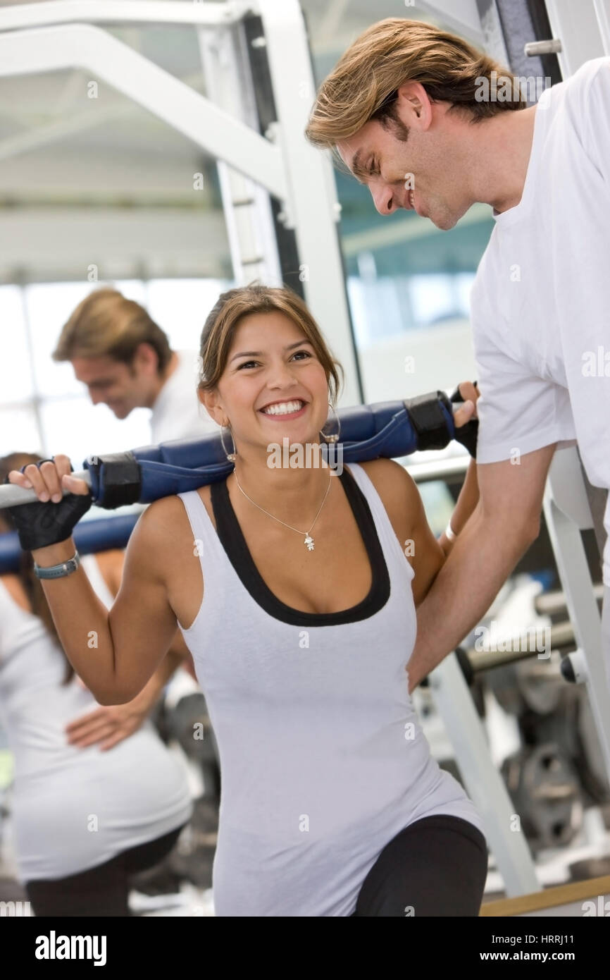 woman and her trainer doing exercise at the gym Stock Photo - Alamy