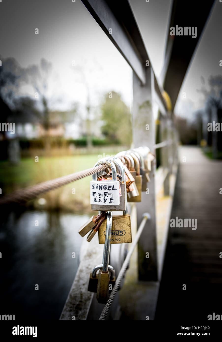 A Bunch of padlocks are attached to a small bridge in Ypres as a way of showing someone your love or not Stock Photo