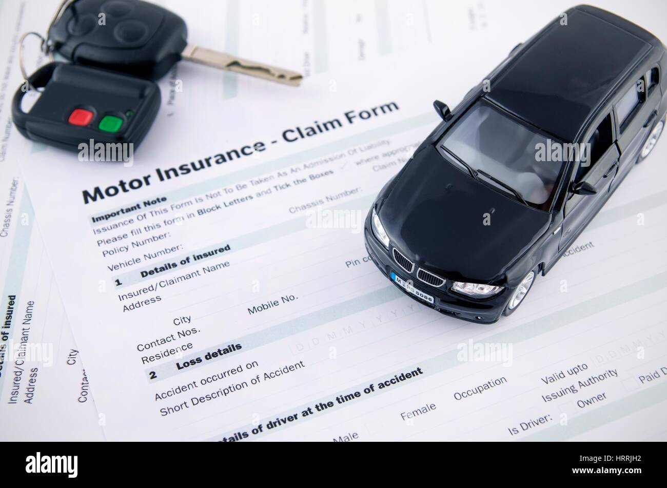 Car toy and keys on insurance documents . Protection car concept Stock Photo