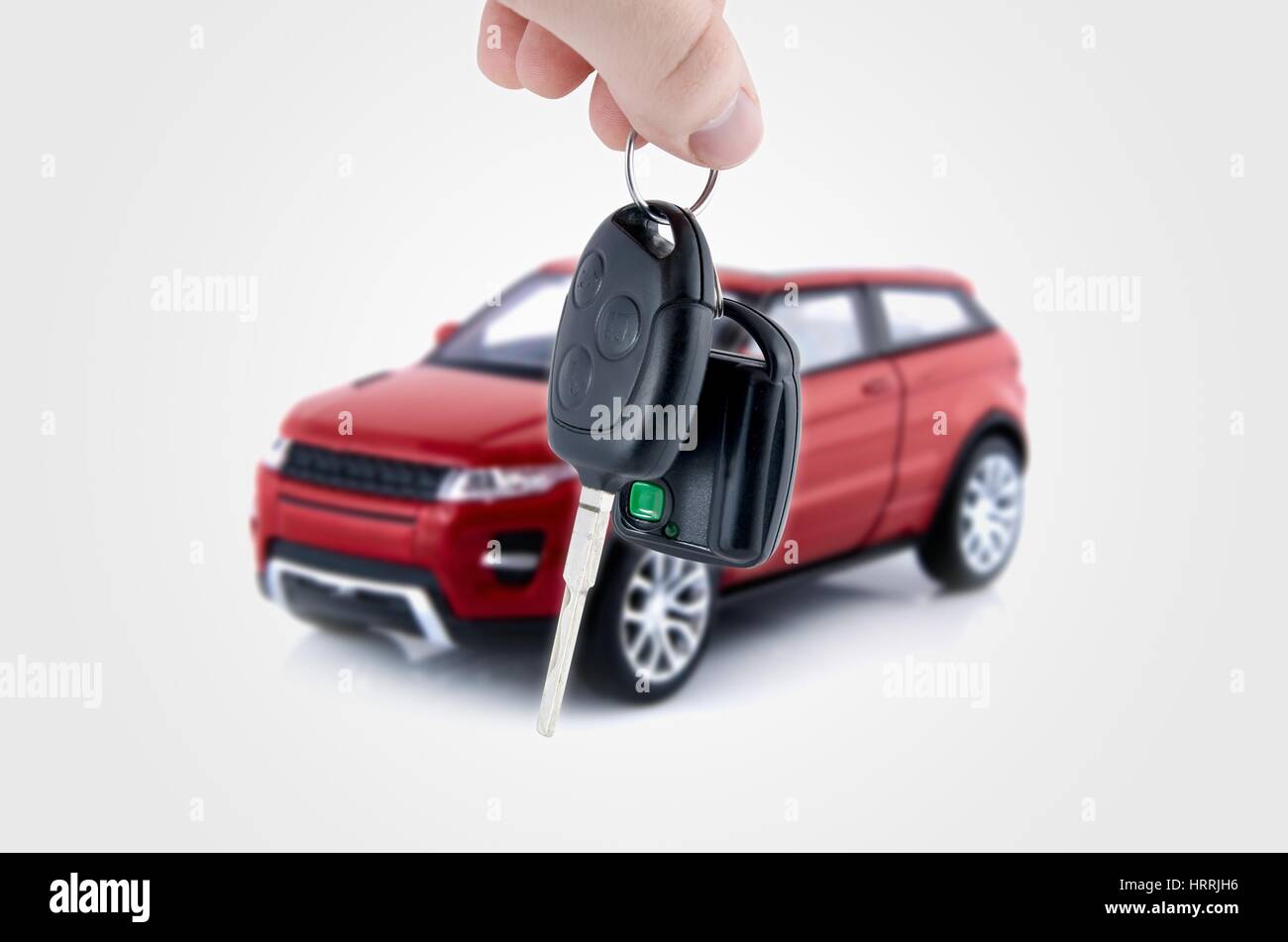 Hand holding keys to new car. Buy or selling business composition Stock Photo