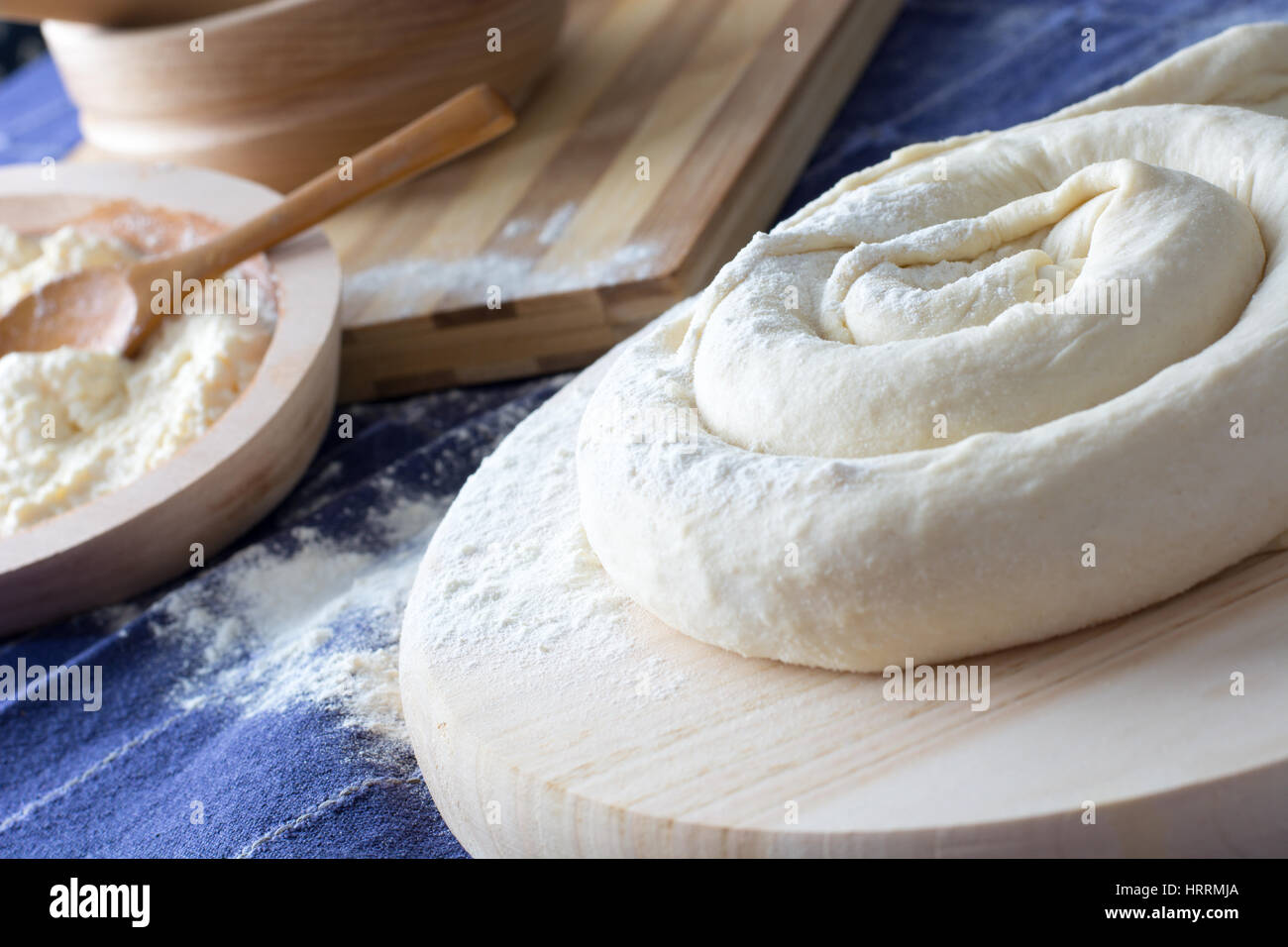 Making of Homemade cheese Pie or other kind of pastry appetizer or sweets on a wooden plate. Cheese pie ready for baking Stock Photo