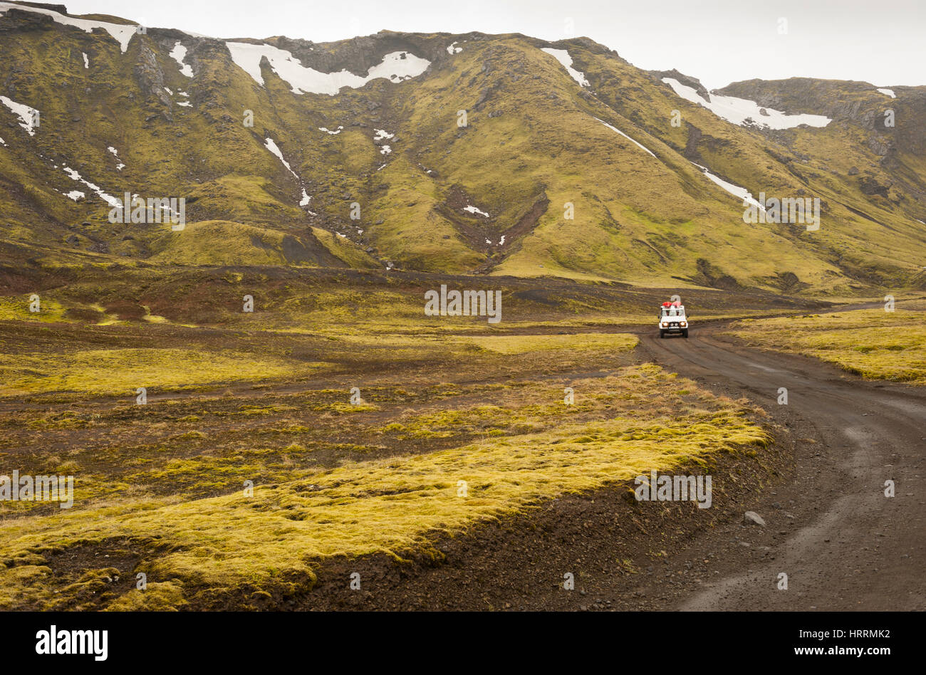 A Land Rover 4x4 off-road vehicle driving along an unpaved road at Laki Craters National Park in Iceland. Stock Photo