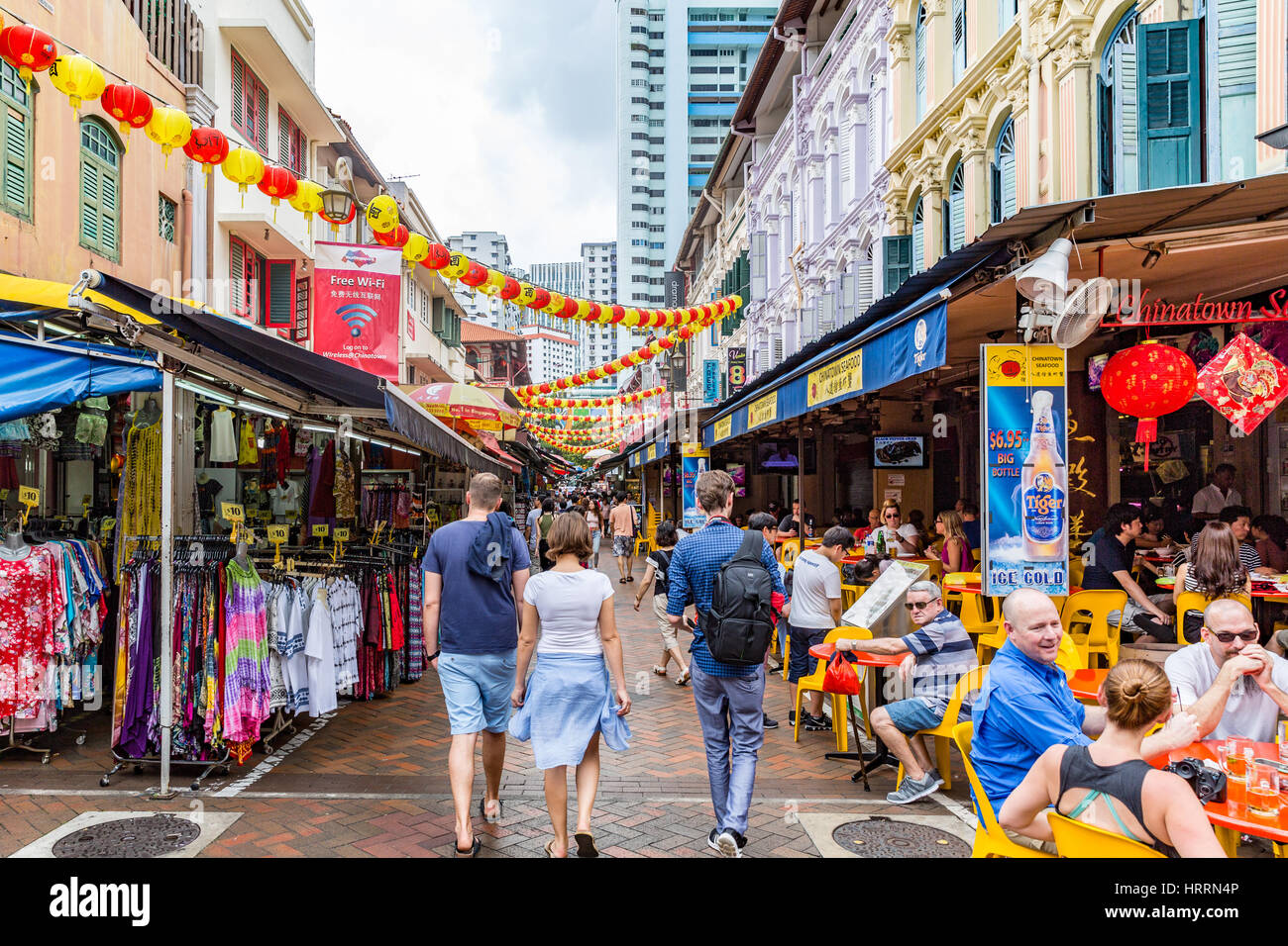Shoppers strole down market street in Chinatown, Singapore Stock Photo