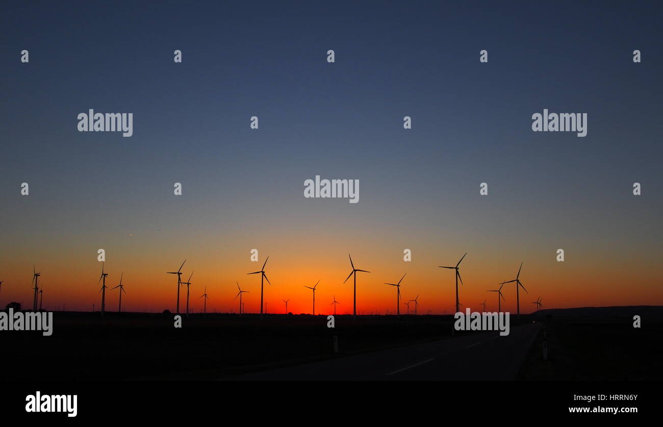 Wind turbines silhouettes on red sky sunset Stock Photo - Alamy