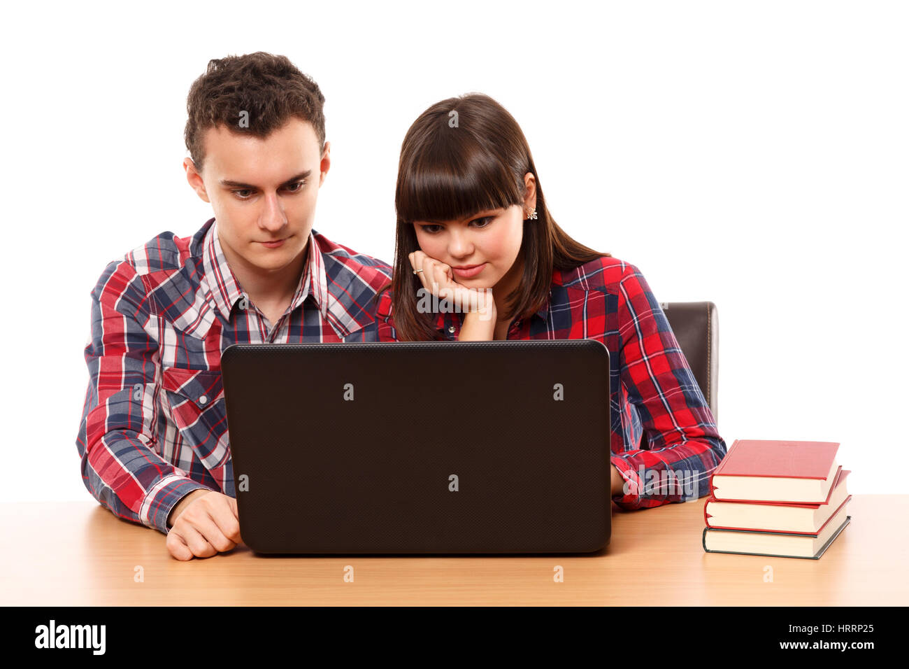 Couple of teenagers studying, doing homework on a laptop Stock Photo ...