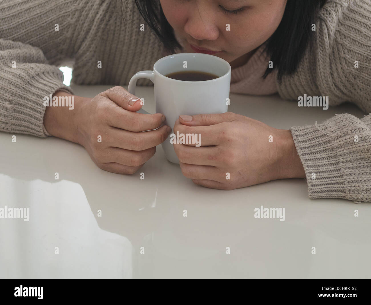 Woman drinking coffee and holding a white mug Stock Photo
