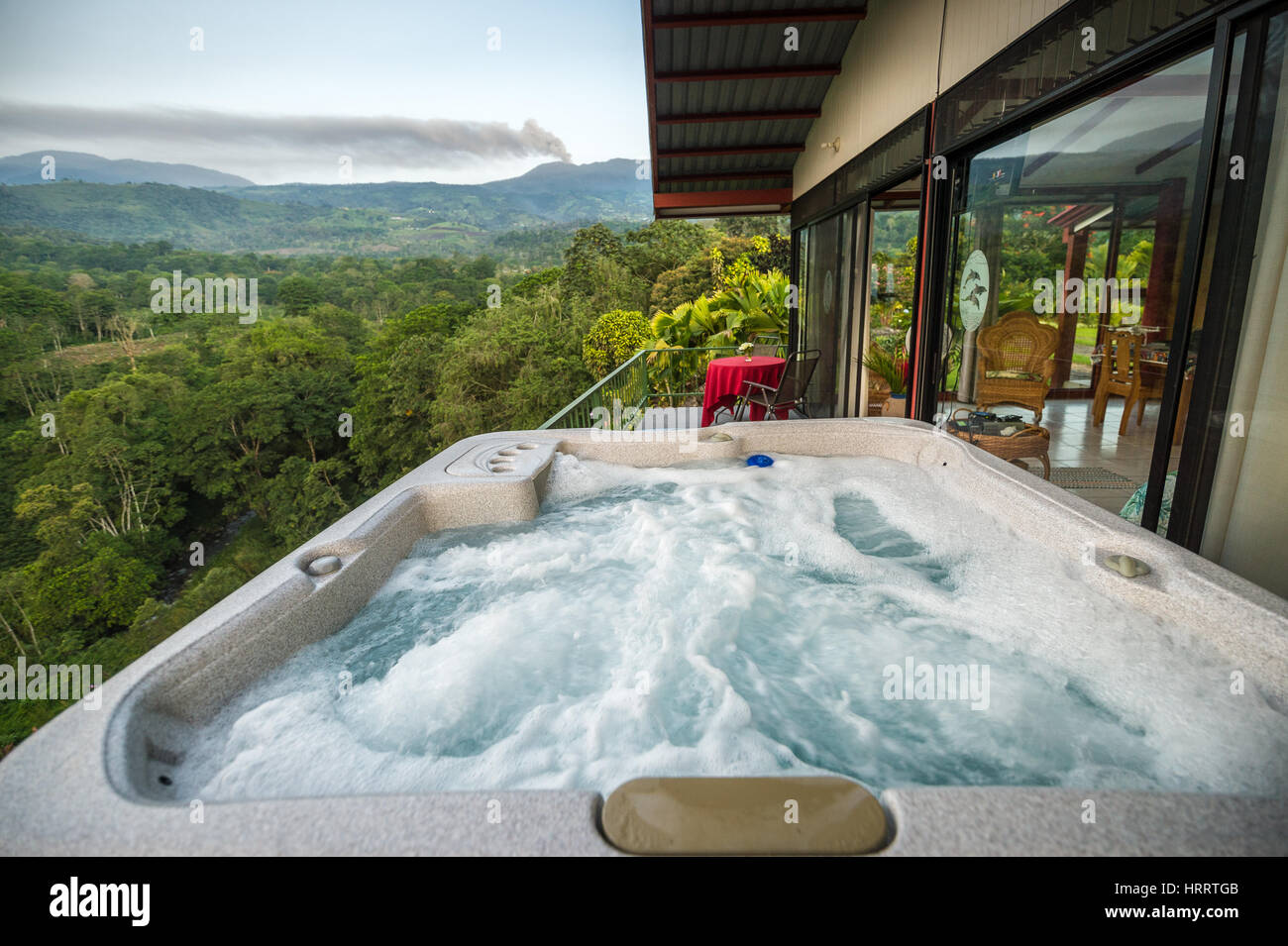 View from the hot tub of a small hillside vacation home, where the lush ... - Luxury Off Grid Homes With Private Hot Tub And Hillside Views