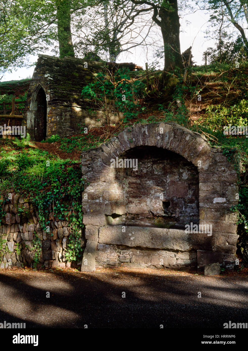 A roadside stone trough fed by a holy well inside a Medieval chapel associated with the legends of St Julian the Hospitaller of Maker, Cornwall. Stock Photo