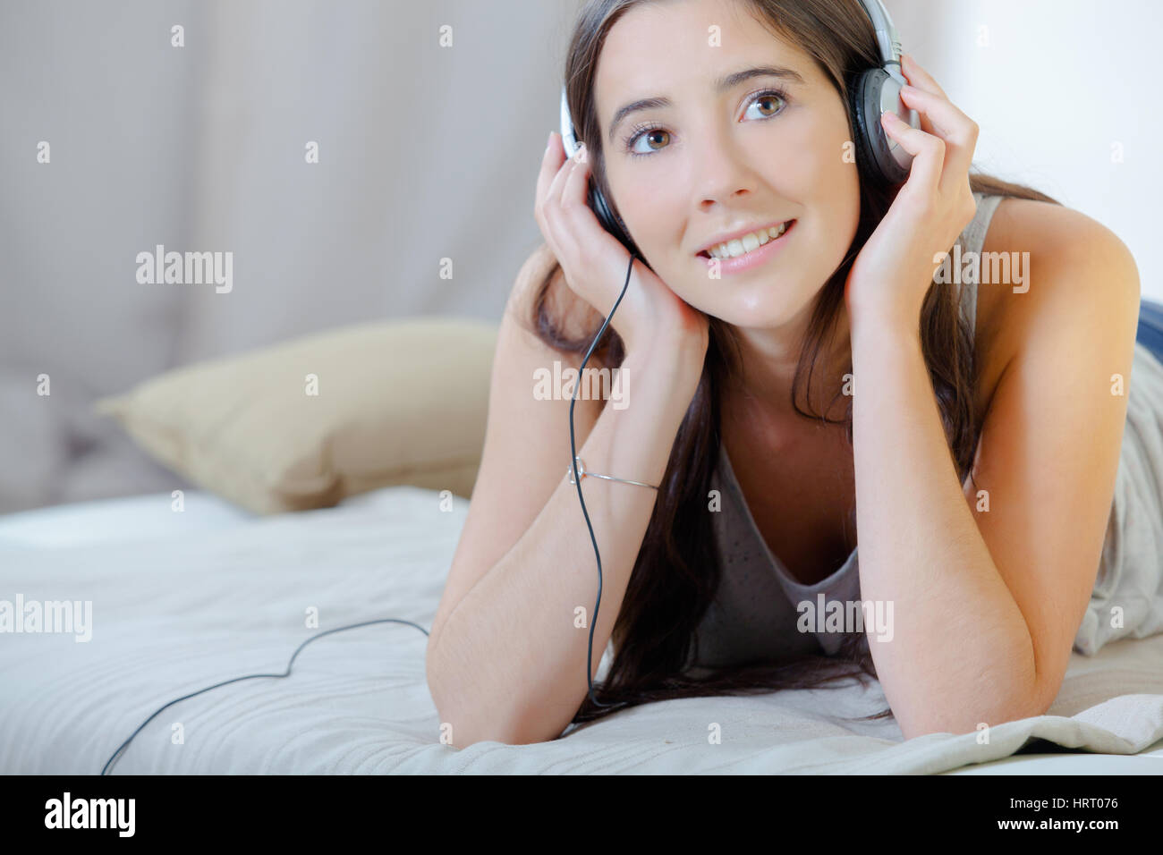 woman listening to music on bed Stock Photo Alamy