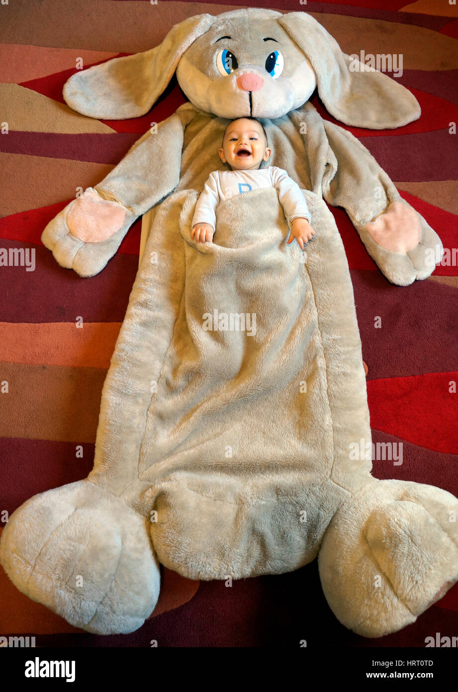 Baby Boy inside a big rabbit peluche Stock Photo