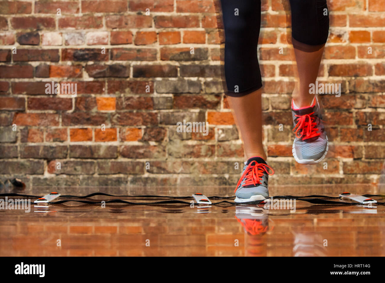 A womans feet and legs working out with a speed ladder / agility ladder