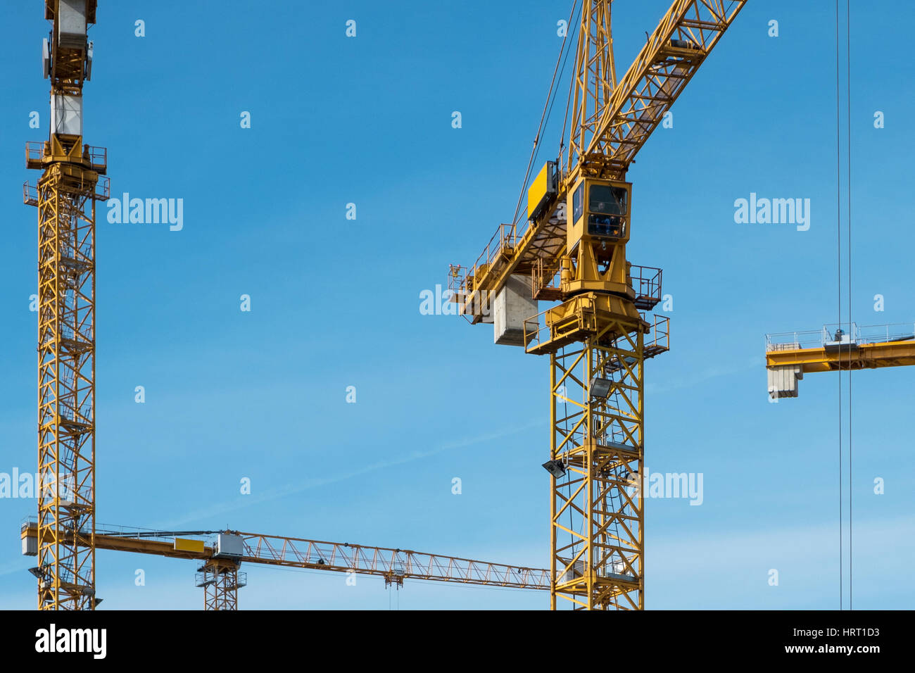many cranes on blue sky at construction site Stock Photo
