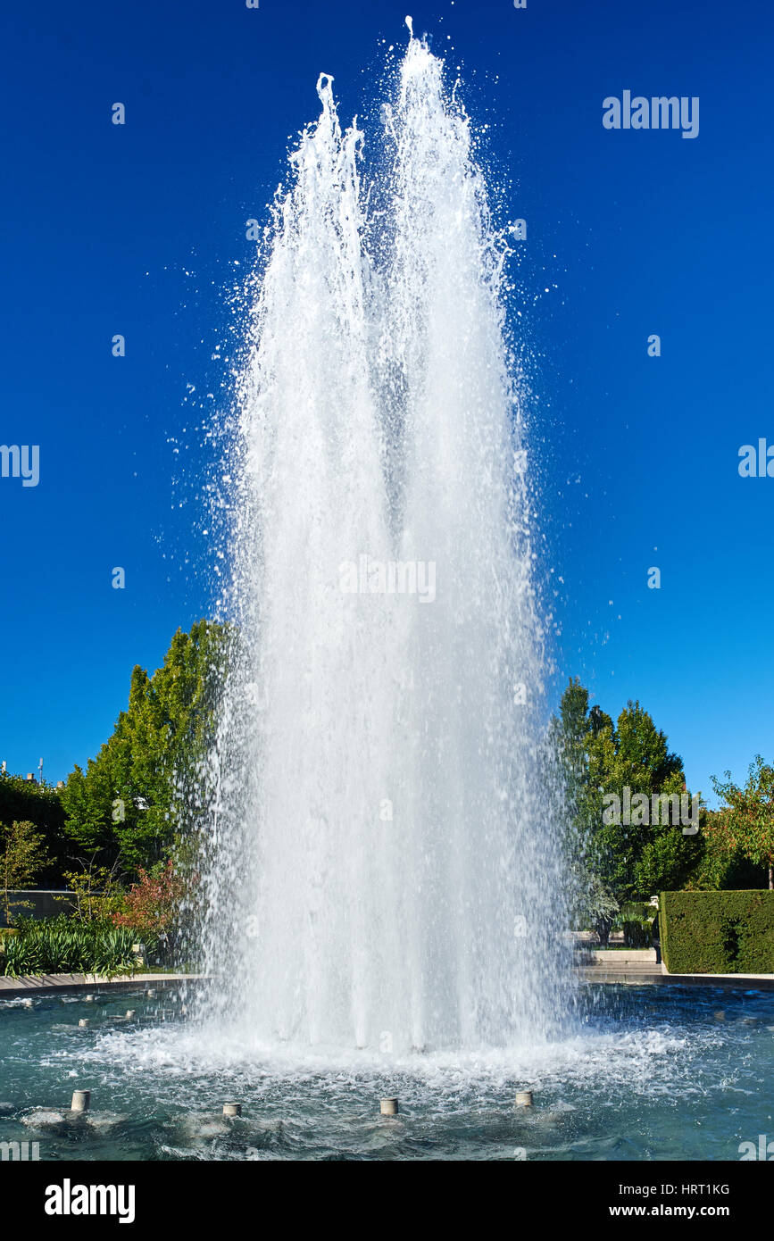 Fountain in a park with blue sky Stock Photo