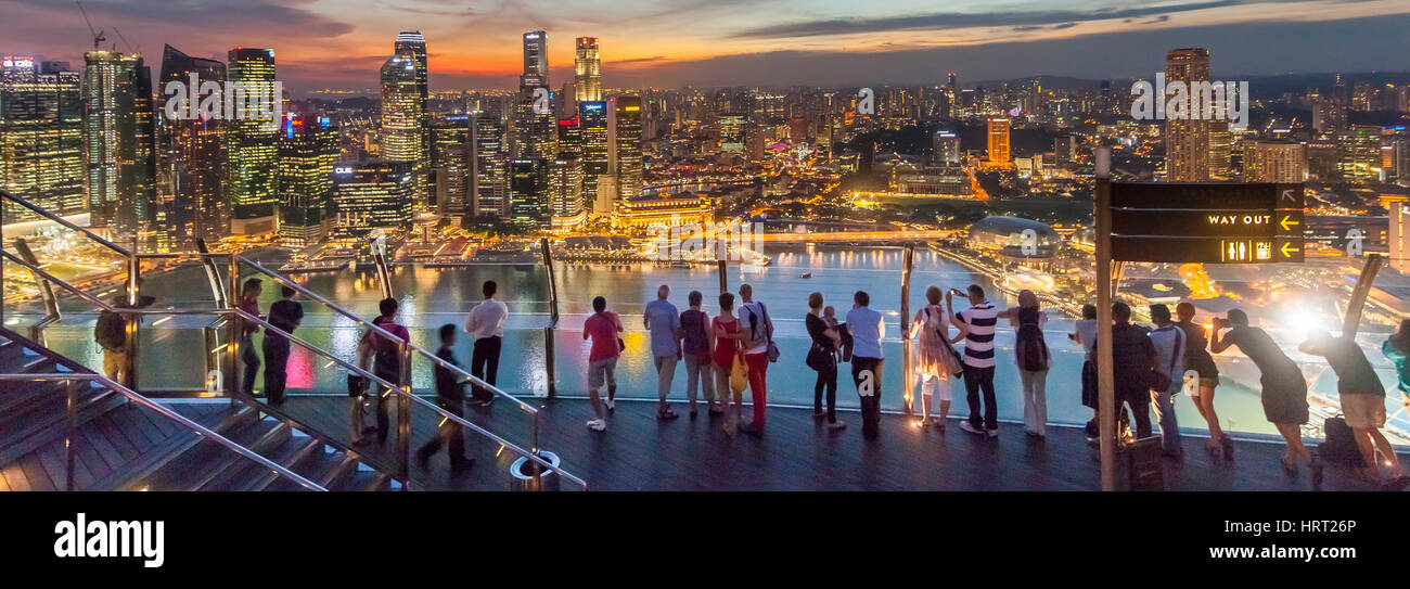 Tourists and visitors looking at the skyline of Singapore, skyline, night view, financial district, banking district, central business district, Marin Stock Photo