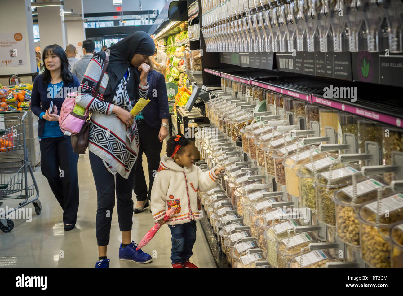 Shoppers choose bulk grains and nuts in the new Whole Foods Market in Newark, NJ on opening day Wednesday, March 1, 2017. The store is the chain's 17th store to open in New Jersey. The 29,000 square foot store located in the redeveloped former Hahne & Co. department store building is seen as a harbinger of the revitalization of Newark which never fully recovered from the riots in the 1960's.  (© Richard B. Levine) Stock Photo