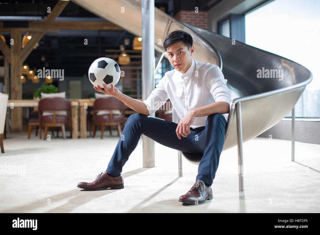 Young businessman holding a soccer ball Stock Photo - Alamy