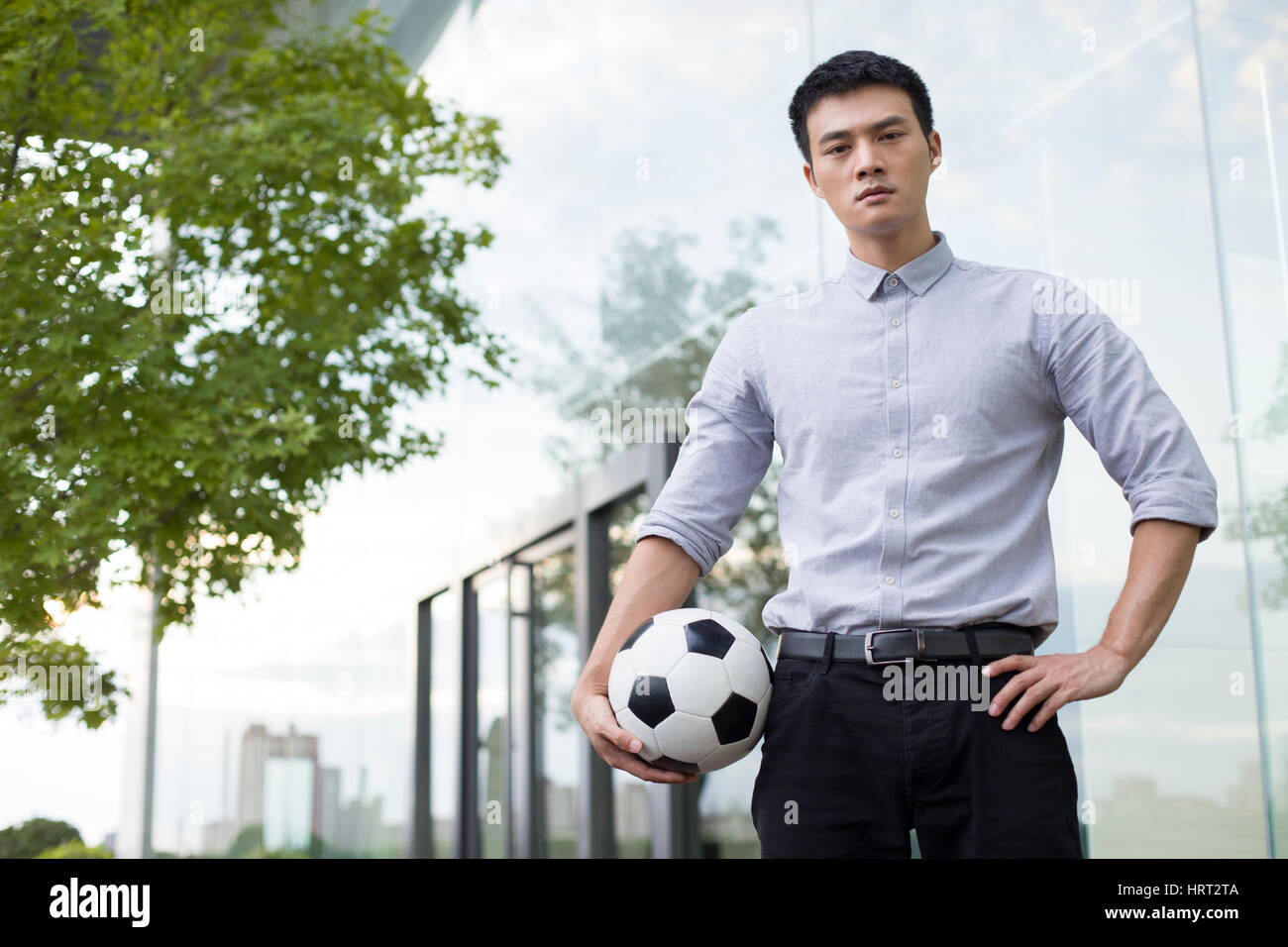 Young businessman holding a soccer ball Stock Photo - Alamy