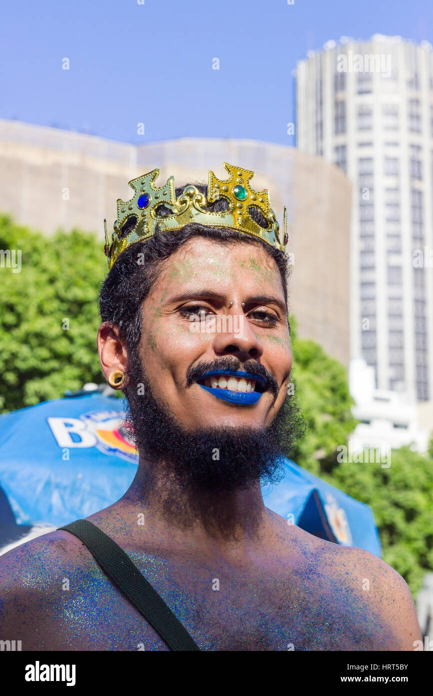 FEBRUARY 8, 2016 - Rio de Janeiro, Brazil - Yonge man with blue lipstick and crown smiling during Carnival Stock Photo