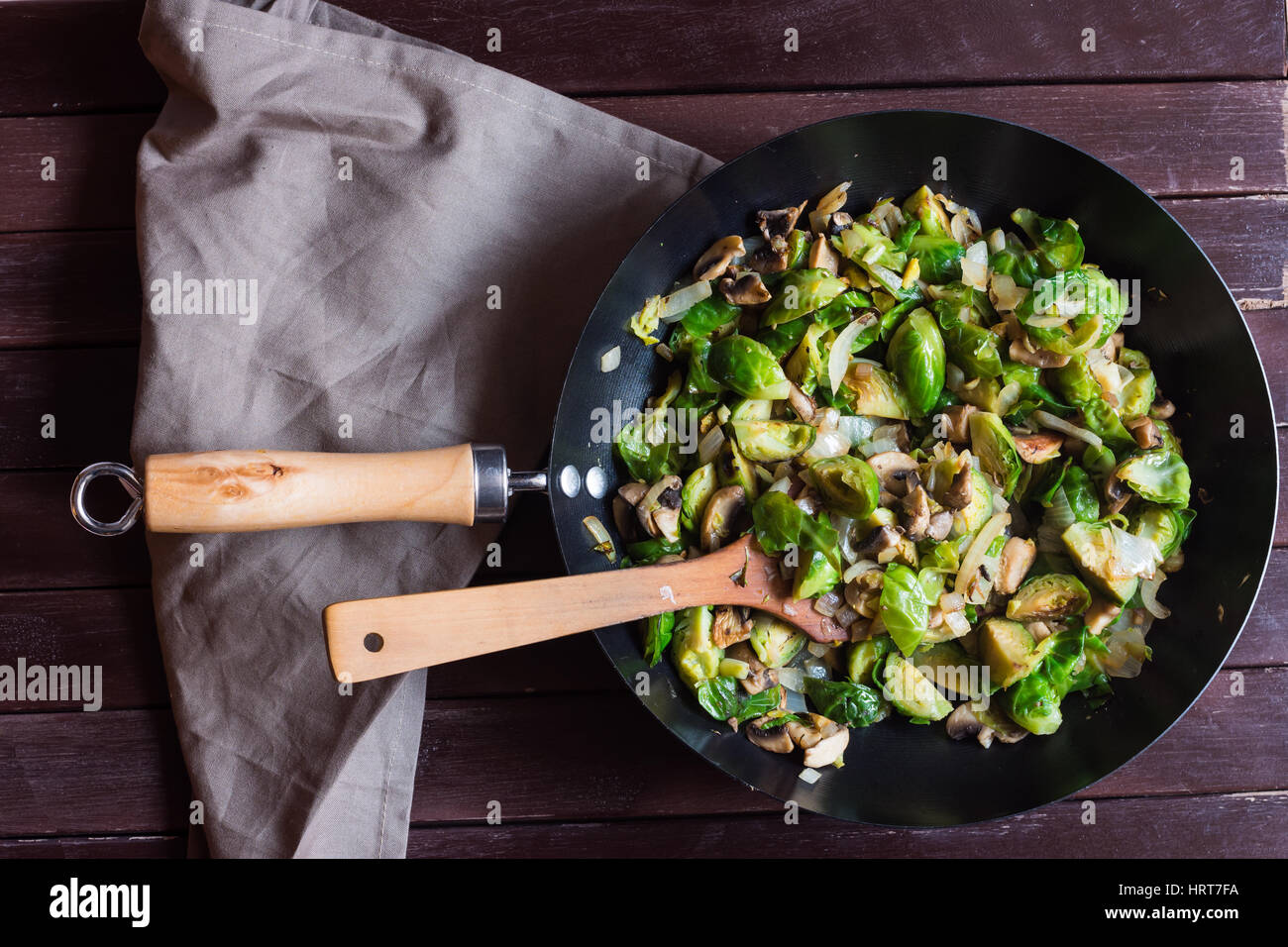 Appetizing sauteed brussels sprouts and champignons in skillet with ...