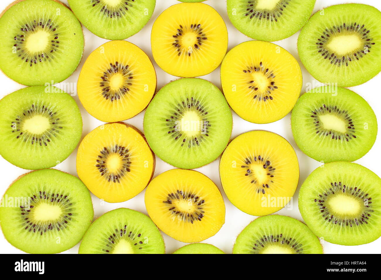 slices of fresh green and yellow kiwi fruits as a food background texture Stock Photo