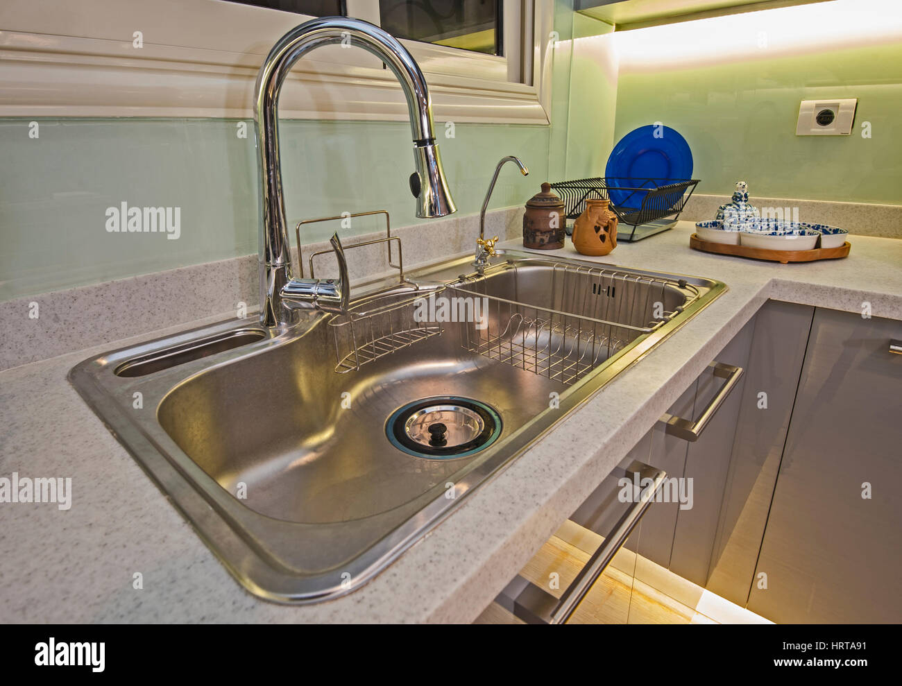 Interior design decor of kitchen in luxury apartment with metal sink and faucet Stock Photo