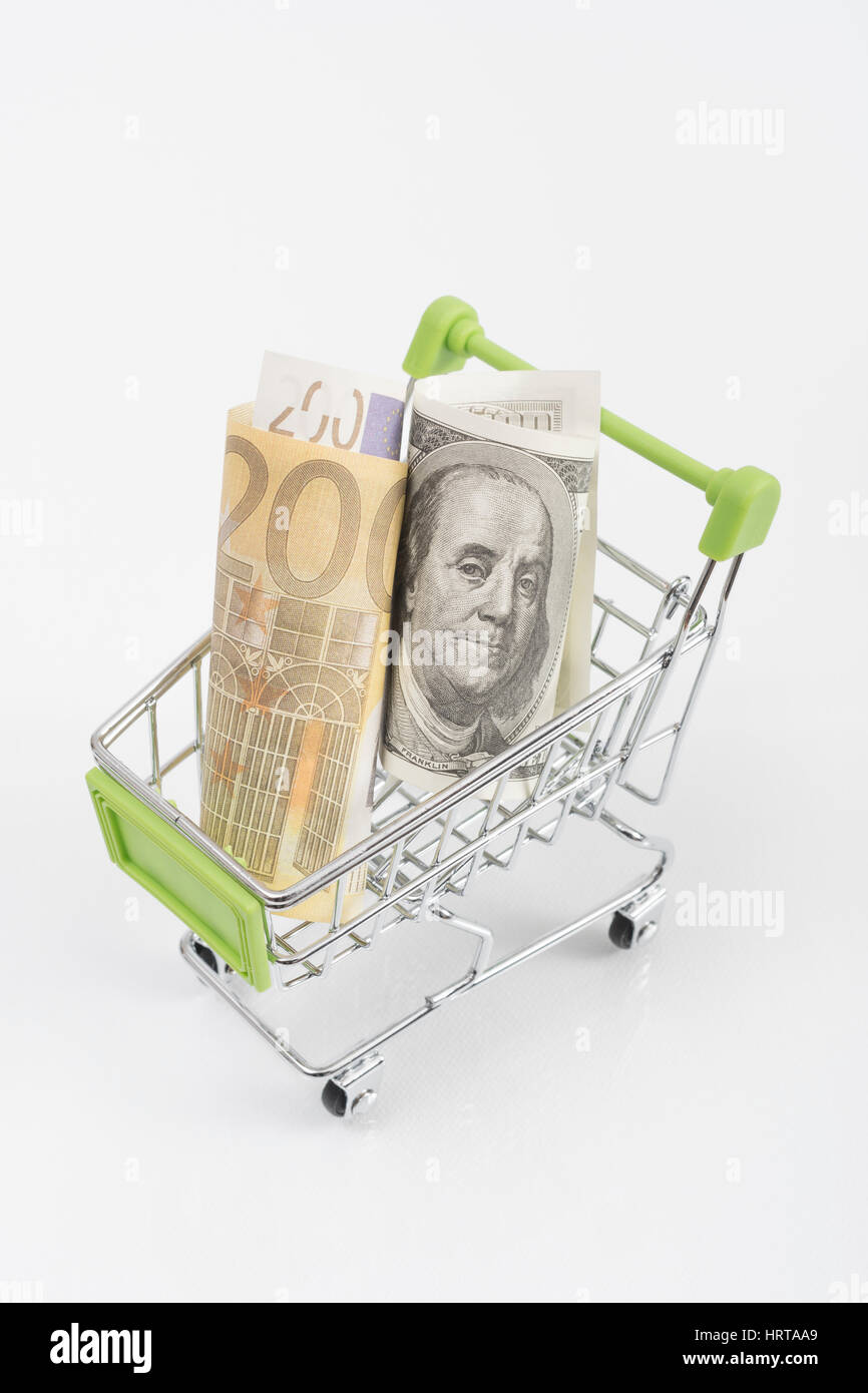 Dollar and Euro  banknotes in shopping cart / trolley. Metaphor for exchange rates, free trade, trade war, globalism. Stock Photo