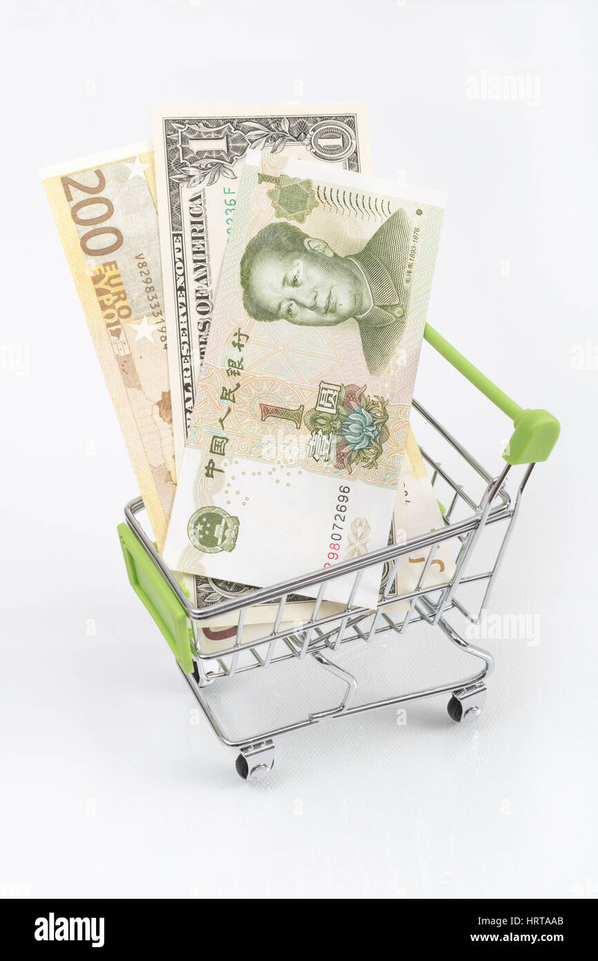 Dollar, Euro and Yuan banknotes in shopping cart / trolley. Metaphor for exchange rates, free trade, trade war, globalism, Yuan weakness. Stock Photo