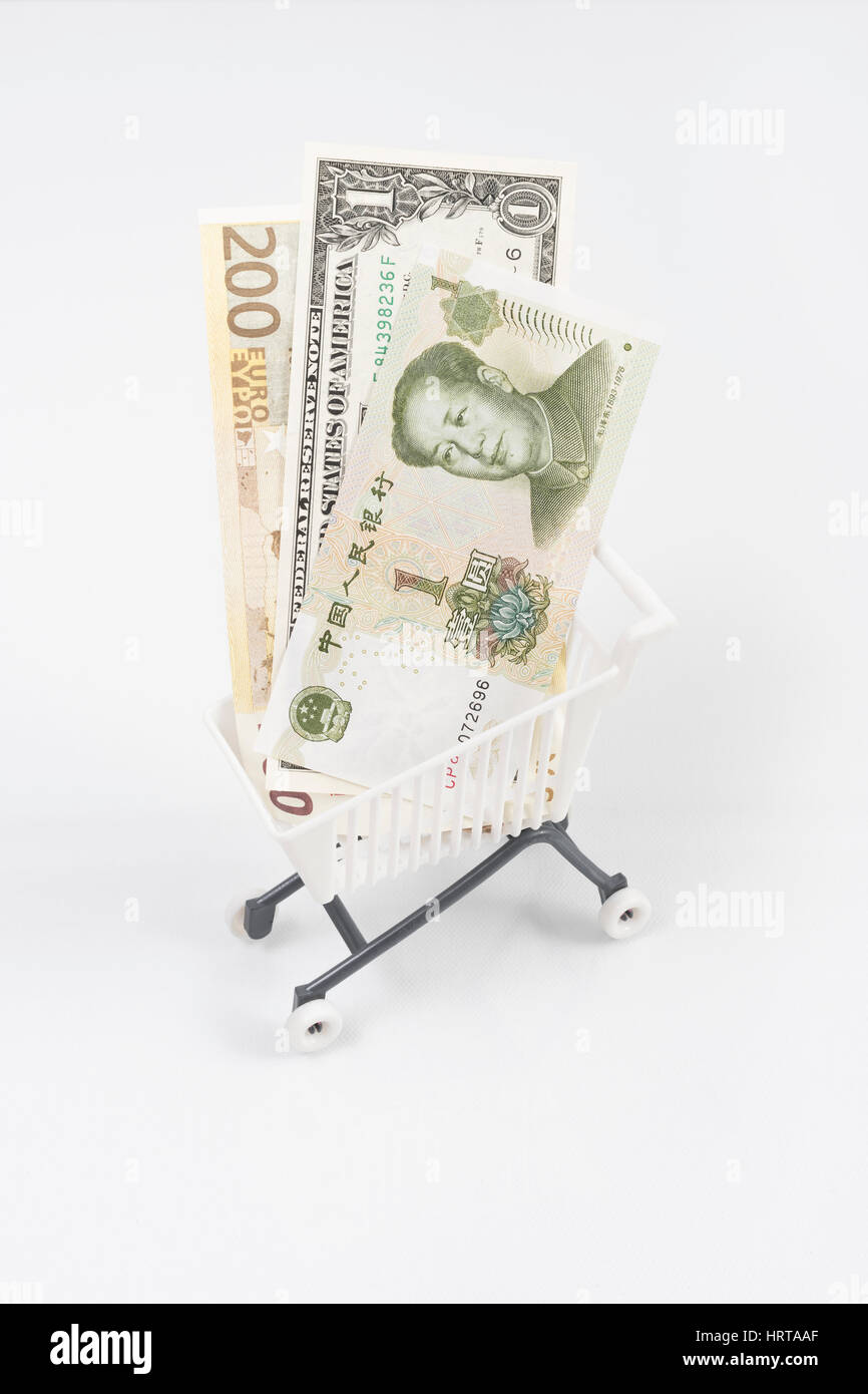 Dollar, Euro and Yuan banknotes in shopping cart / trolley. Metaphor for exchange rates, free trade, trade war, globalism, Yuan weakness. Stock Photo