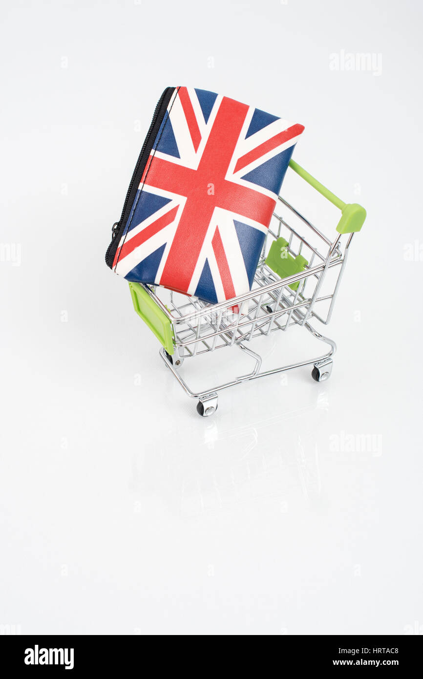 Union Jack coin purse / wallet in a toy shopping trolley. Metaphor for UK consumer spending, the economy, retail/high street sales, cost of living. Stock Photo