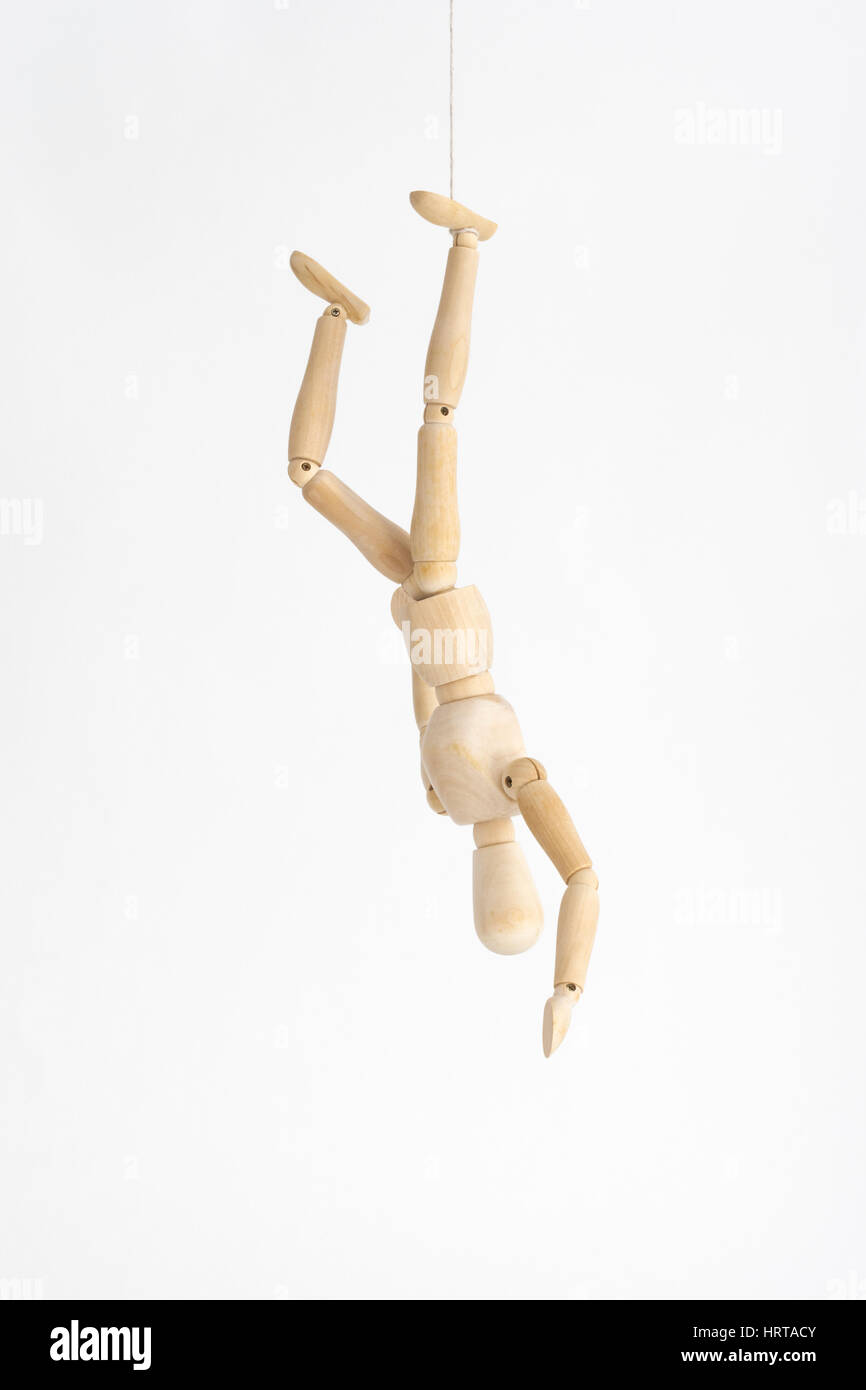 Artist's mannequin hanging mid-air by a piece of string - metaphor for ' hanging on by a thread', 'up in the air' metaphor, uncertain future Stock  Photo - Alamy