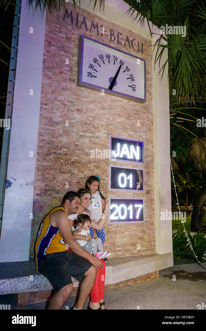 Miami Beach Florida,time temperature clock,Hispanic family posing,New Year's Day,January 1 1st,FL170101012 Stock Photo