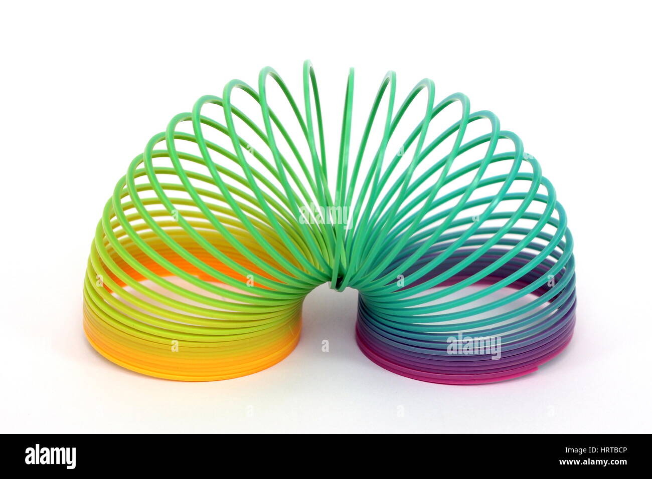 Multi-colored plastic slinky toy - spring Stock Photo