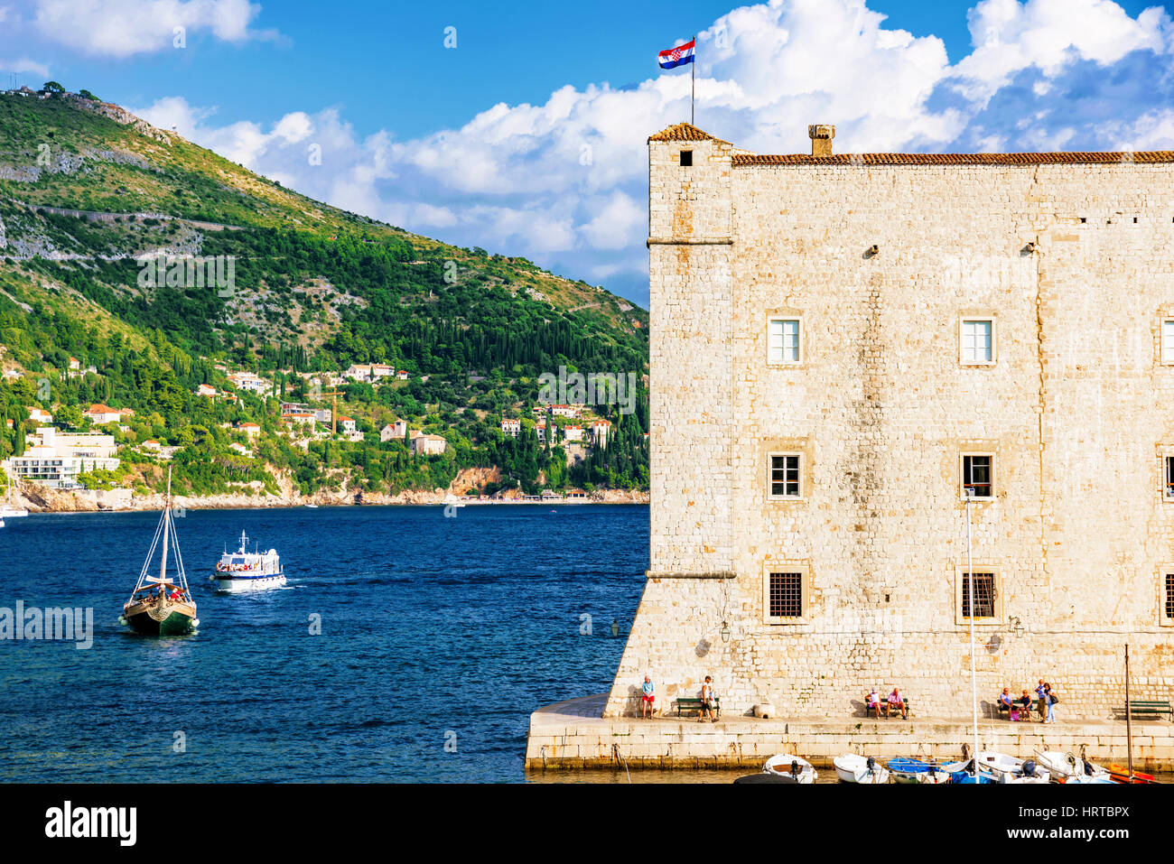 DUBROVNIK, CROATIA - SEPTEMBER 22: Castle wall and harbor area of Dubrovnik's seafront with boats and nature on September 22, 2016 in Dubrovnik Stock Photo