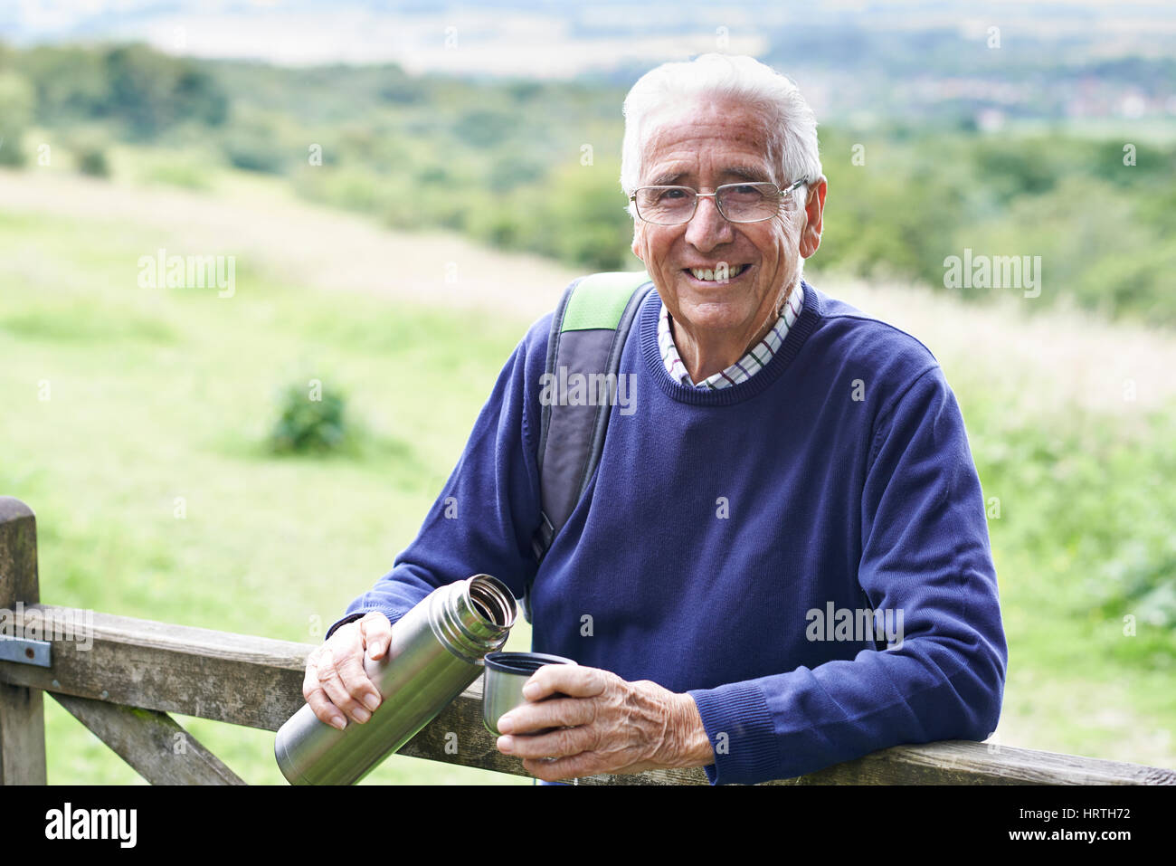 Senior Man On Hike Having Hot Drink Stock Photo