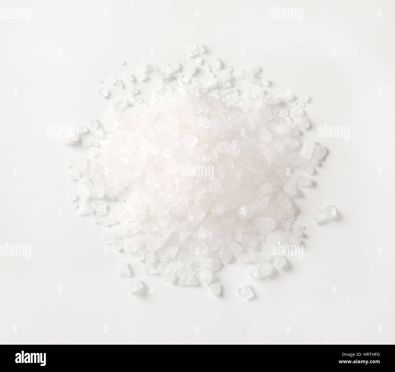 pile of coarse grained salt on white background Stock Photo - Alamy