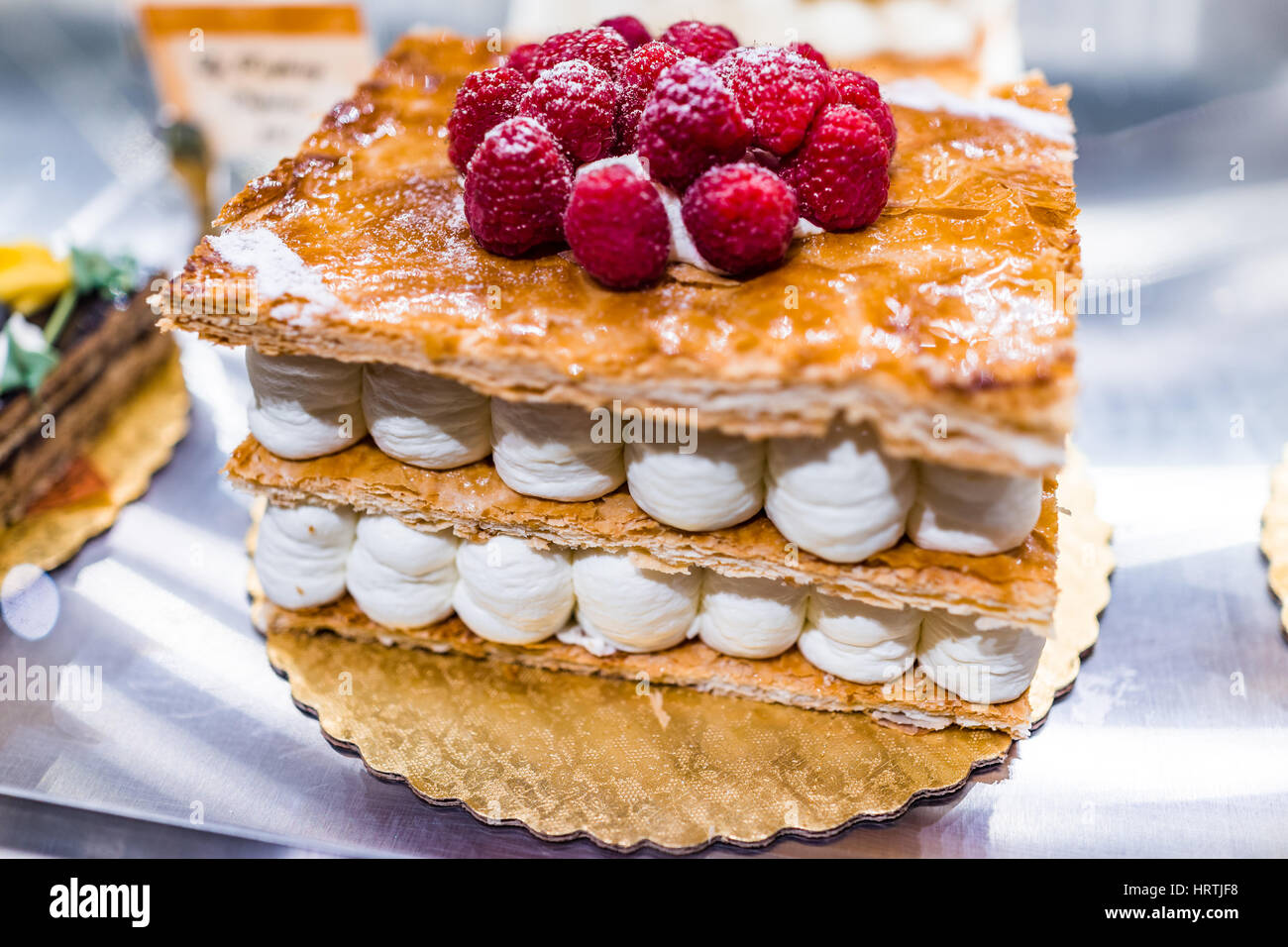 Puff pastry cake in bakery with whipped cream layers Stock Photo