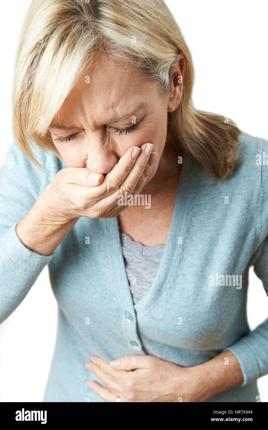 Studio Shot Of Mature Woman Suffering From Nausea Stock Photo