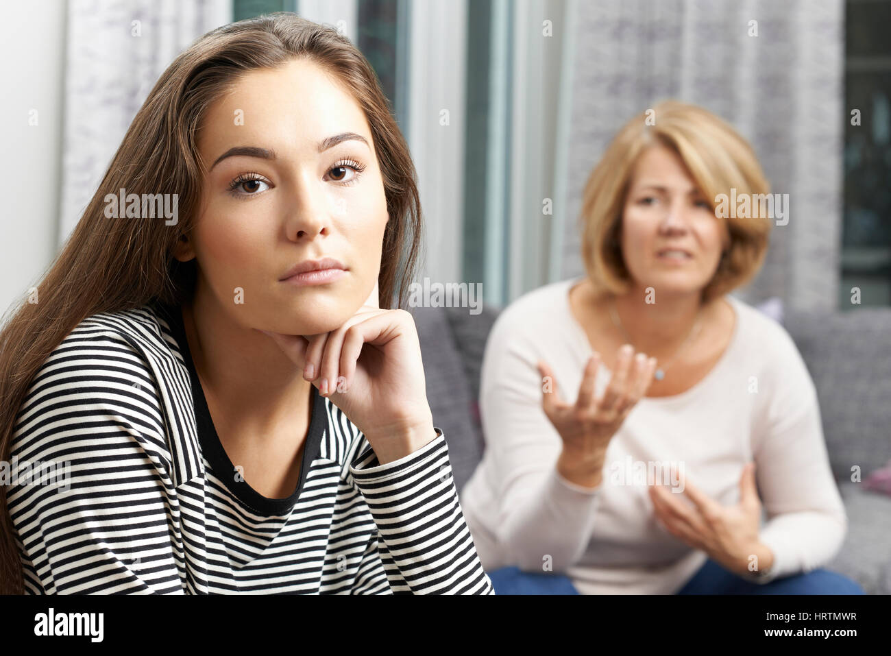 Bored Teenage Girl Being Told Off By Mother Stock Photo