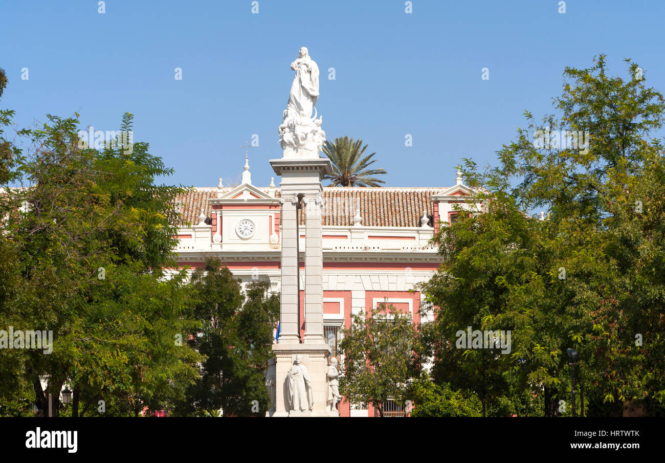 Statue on plinth historic central areas in Plaza del Triunfo, Seville, Spain Stock Photo