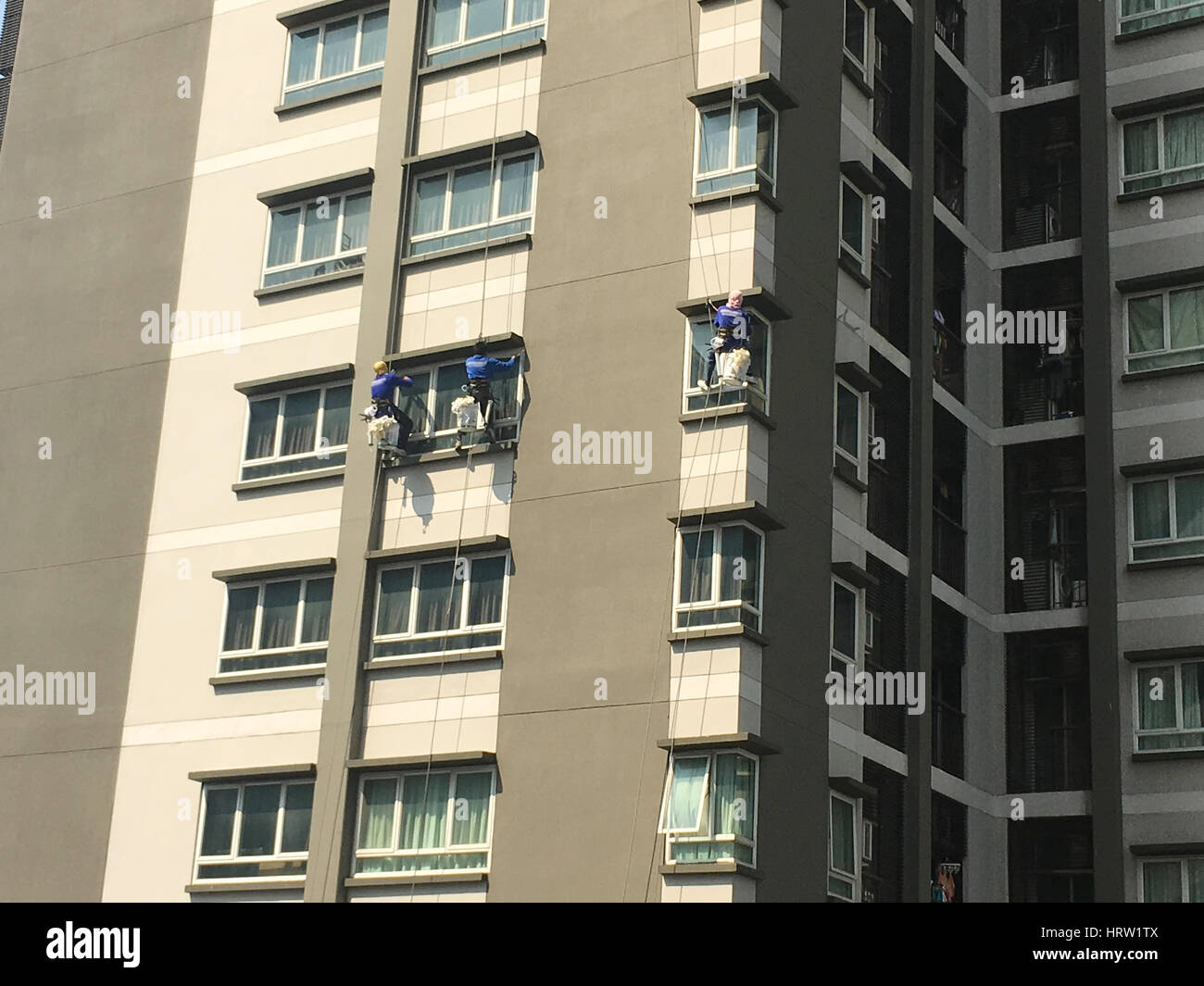 Three climbers maintenance windows and glass Stock Photo