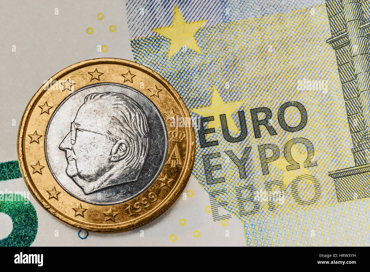 a 1 euro coin from Belgium on a 5 euro banknote Stock Photo