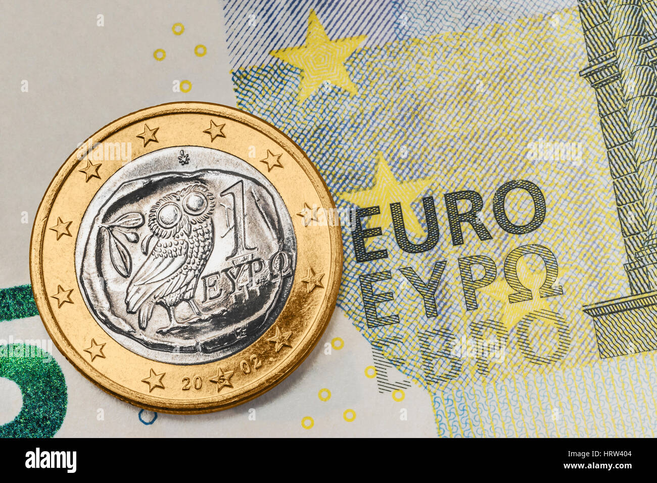 a 1 euro coin from Greece on a 5 euro banknote Stock Photo